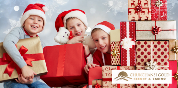 Three young boys opening their Christmas presents.