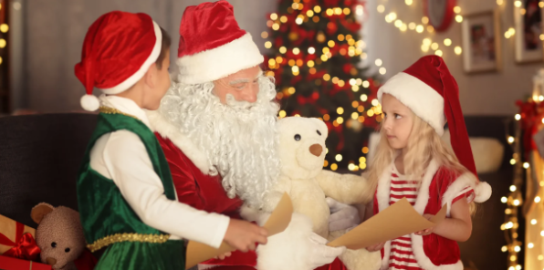 Two children reading their wish lists with Santa Claus.